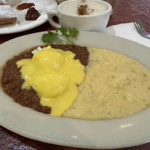 Cajun breakfast plate with poached eggs and jalapeño cheddar grits