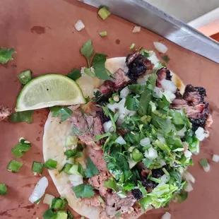 Texas Two-Step taco  - brisket and jalepeno sausage with cilantro and onion