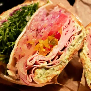 Mortadella  Tapenade, bagna cauda mayo, hot pepper chili relish, provolone, tomato, red onion, and arugula.