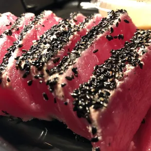 a piece of tuna with black sesame seeds