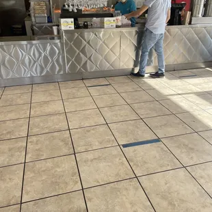 two people standing at a counter
