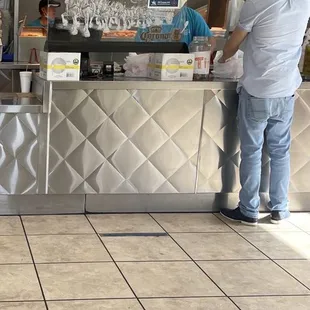 Employee in the kitchen no mask and customer ordering at the counter no mask!