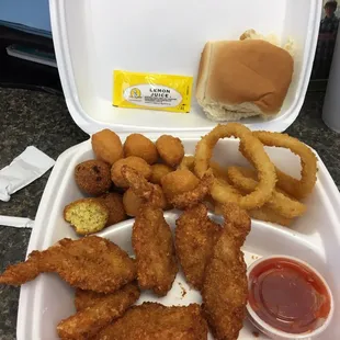 Fried shrimp, hush puppies, corn nuggets &amp; onion rings; bonus is the delicious sweet-ish roll.
