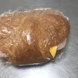a sandwich wrapped in plastic