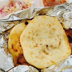 One chicken pupusa and one Revuelta