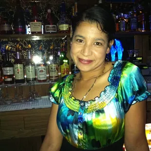 a woman standing at a bar