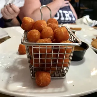 a basket of fried donuts on a plate