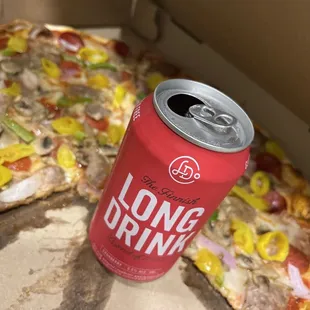 a can of long drink next to a slice of pizza