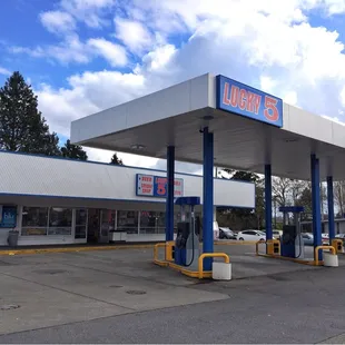 a gas station with a sky background