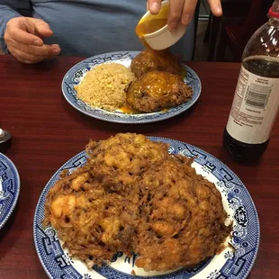 a person sitting at a table with plates of food
