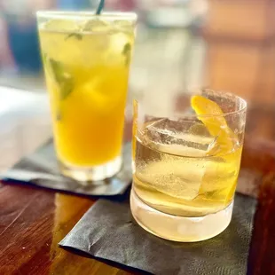 a glass of lemonade next to a glass of lemonade