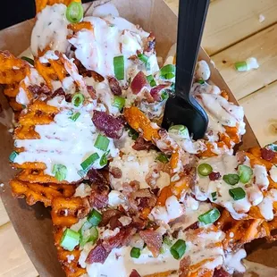 Loaded Sweet Potato Waffle Fries: Sweet potato waffle fries, buttermilk dressing, Cotija cheese, bacon, scallions.