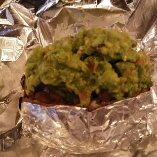 Baked Potato with beans and guacamole on it.