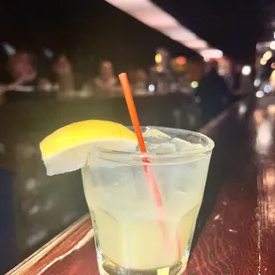 a glass of lemonade on a bar
