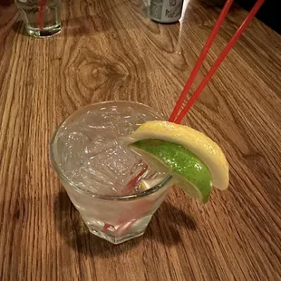 a drink with a lime wedge in a glass