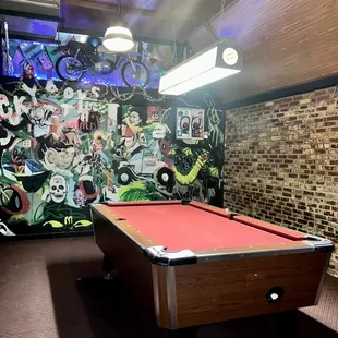 a pool table with a red cloth
