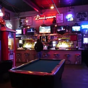 a pool table and neon signs