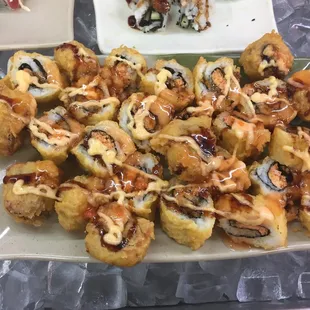 a plate of sushi rolls and a plate of sushi rolls