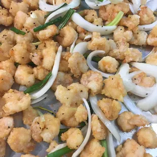 a tray of fried shrimp and onions