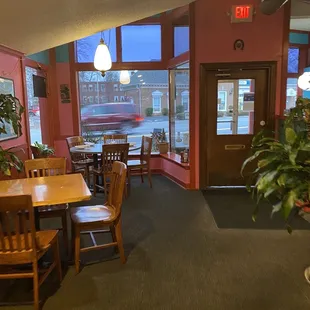a view of a dining area with tables and chairs
