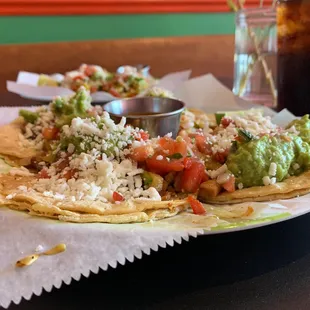 Al pastor and brisket tacos. Veggie taco background.