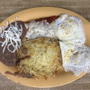 Enchiladas, eggs, beans and hash browns.