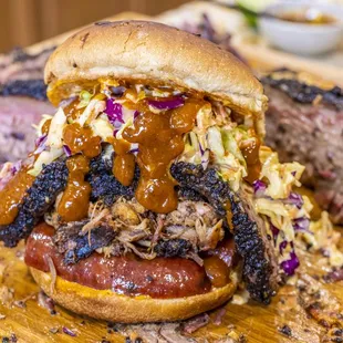 The Lucky Cat : 12hr Mesquite Smoked Brisket, Sambal Chili Pulled Pork, Smoked Beef Jalapeno Cheddar Sausage, House Slaw, Sriracha Aioli