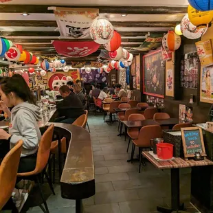 people sitting at tables in a restaurant