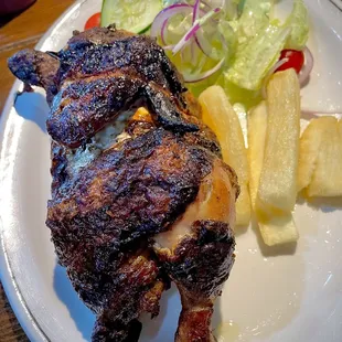 Peruvian half chicken with house salad and yuca fries