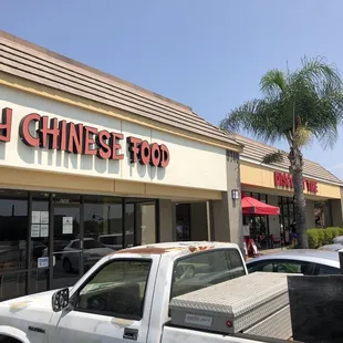 a pickup truck parked in front of the store