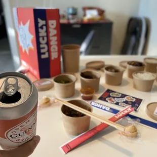 a person holding a can of beer