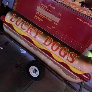 a hot dog on a cart