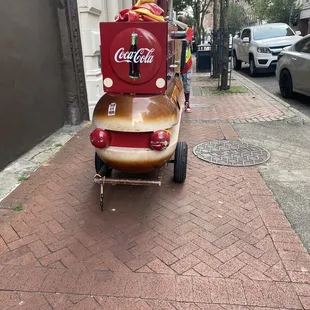 a coca cola cart on a city street