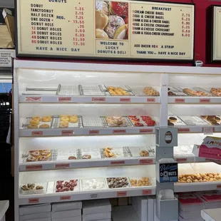 Inside: peering behind the counter at the donuts waiting to go home with me today