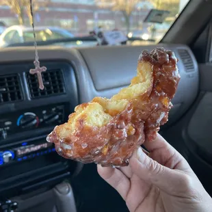 a hand holding a doughnut