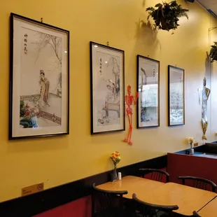 a wall of asian art in a restaurant
