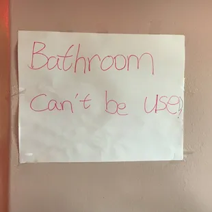 a bathroom sign on a wall