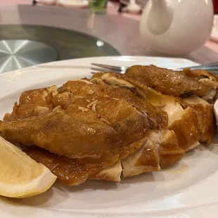 a plate of food with a lemon wedge
