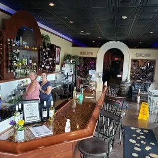 two women standing at the bar
