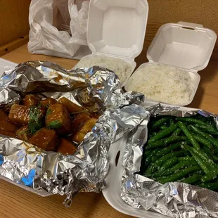 a tray of food and a container of rice