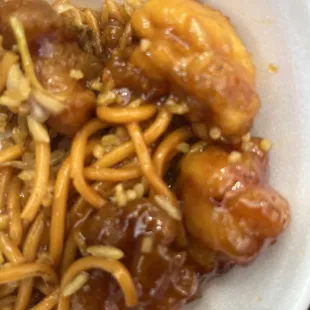 A bowl with chow mein and fried rice and orange chicken. The bowl was $10