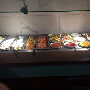a variety of food items on a buffet table