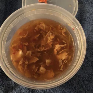 a bowl of soup and a container of soup
