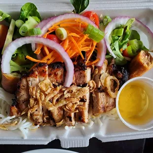 Delicious Ginger Noodle Bowl, topped with grilled pork and pork egg roll pieces!