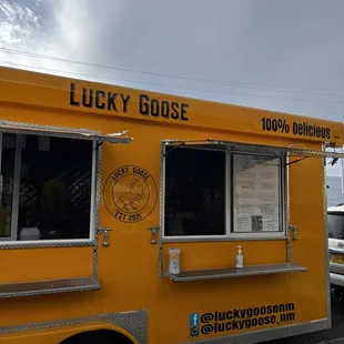 a yellow food truck parked in a parking lot