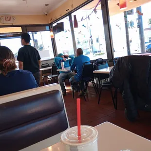 people sitting at tables in a restaurant