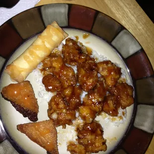 Shrimp toast, spring roll, General Tso chicken on white rice.