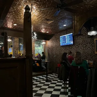 people sitting at tables in a restaurant