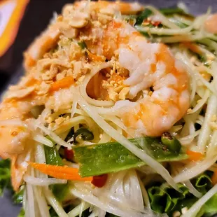 a plate of salad with shrimp and vegetables