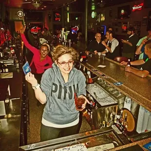 a woman standing at a bar